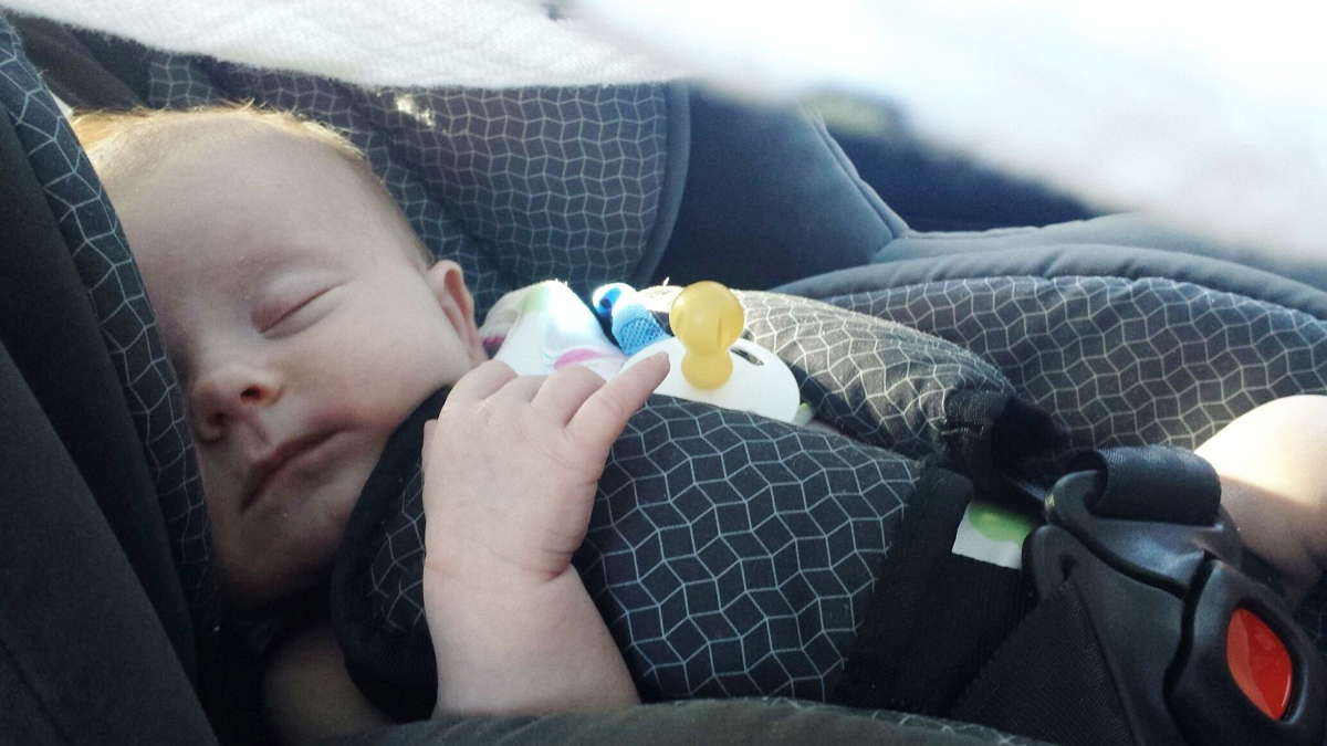 Zdjęcie z niemowlkaiem śpiącym w foteliku samochodowym
